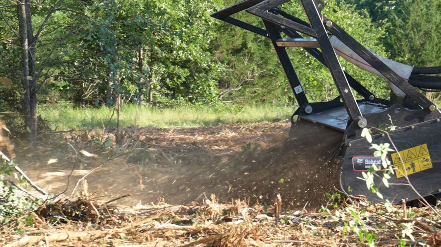 Forestry mulching head grinding brush and small trees on a Northwest Arkansas property