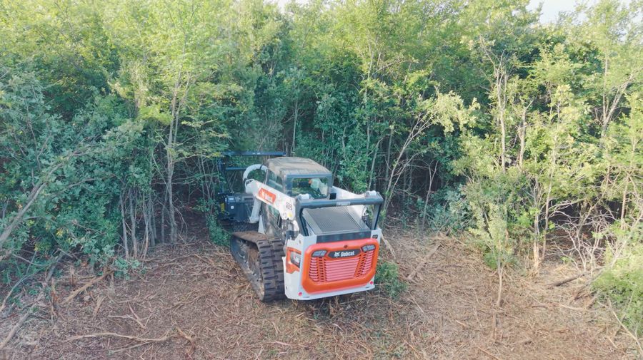 Bobcat T86 with forestry mulching head clearing dense brush on an Oklahoma property